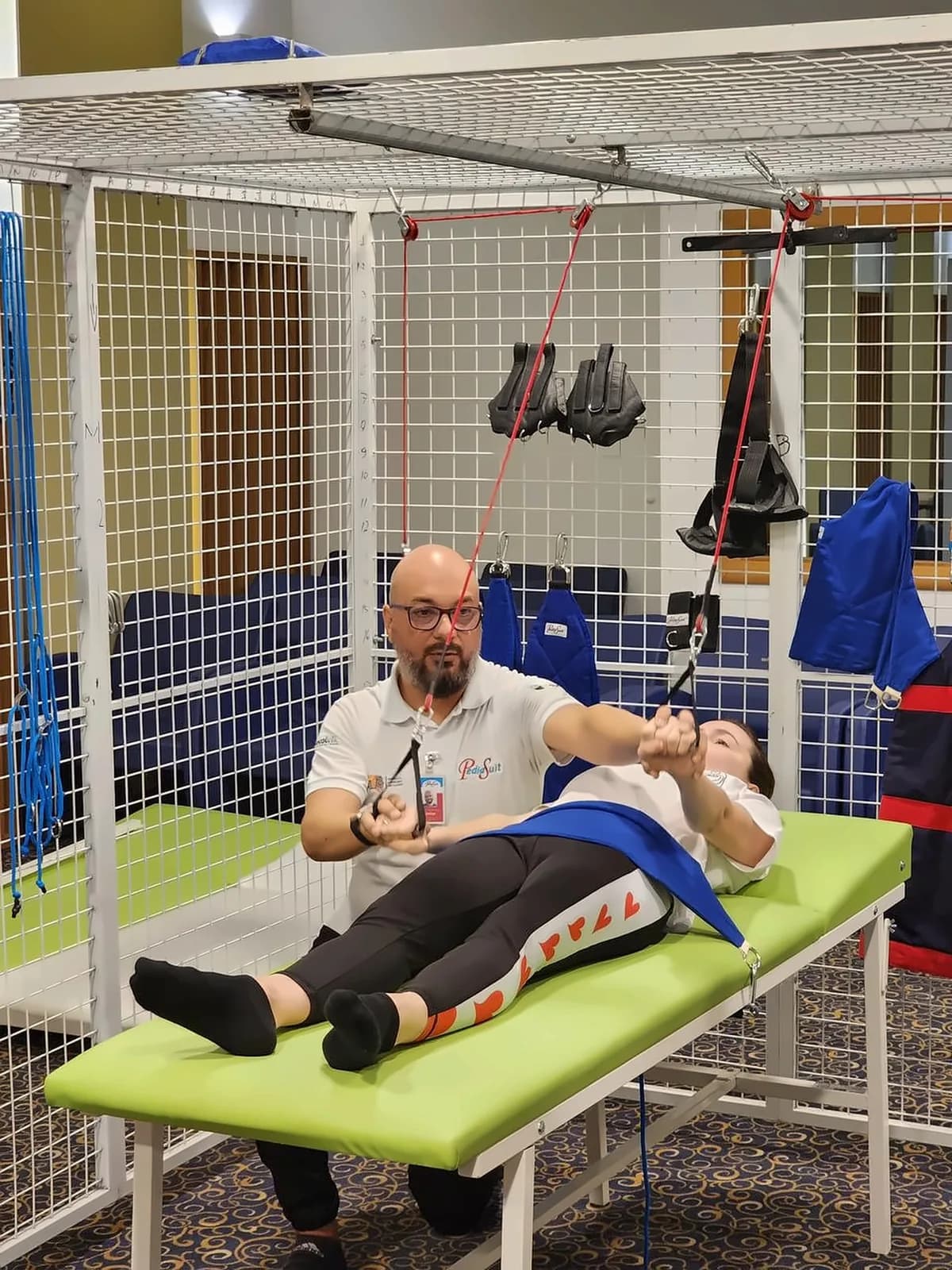 A therapist working with a patient on the treatment table